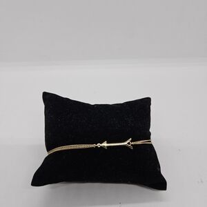 Stella & Dot gold tone and yellow drawstring bracelet with arrow charm